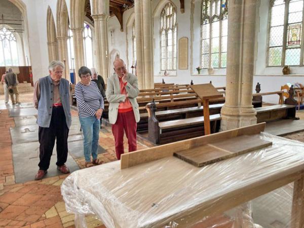 The table arrives, contemplated by members of the Fabric Subcommittee, Charles M